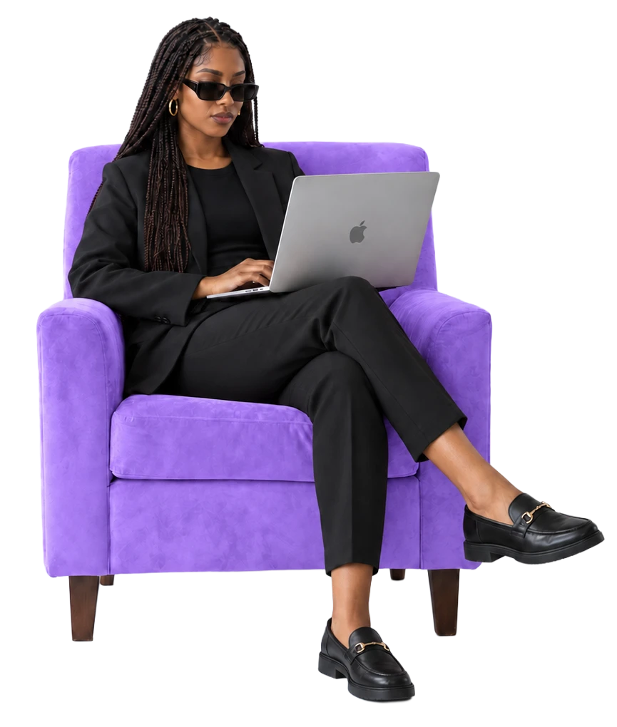 Woman working on a laptop in a purple armchair