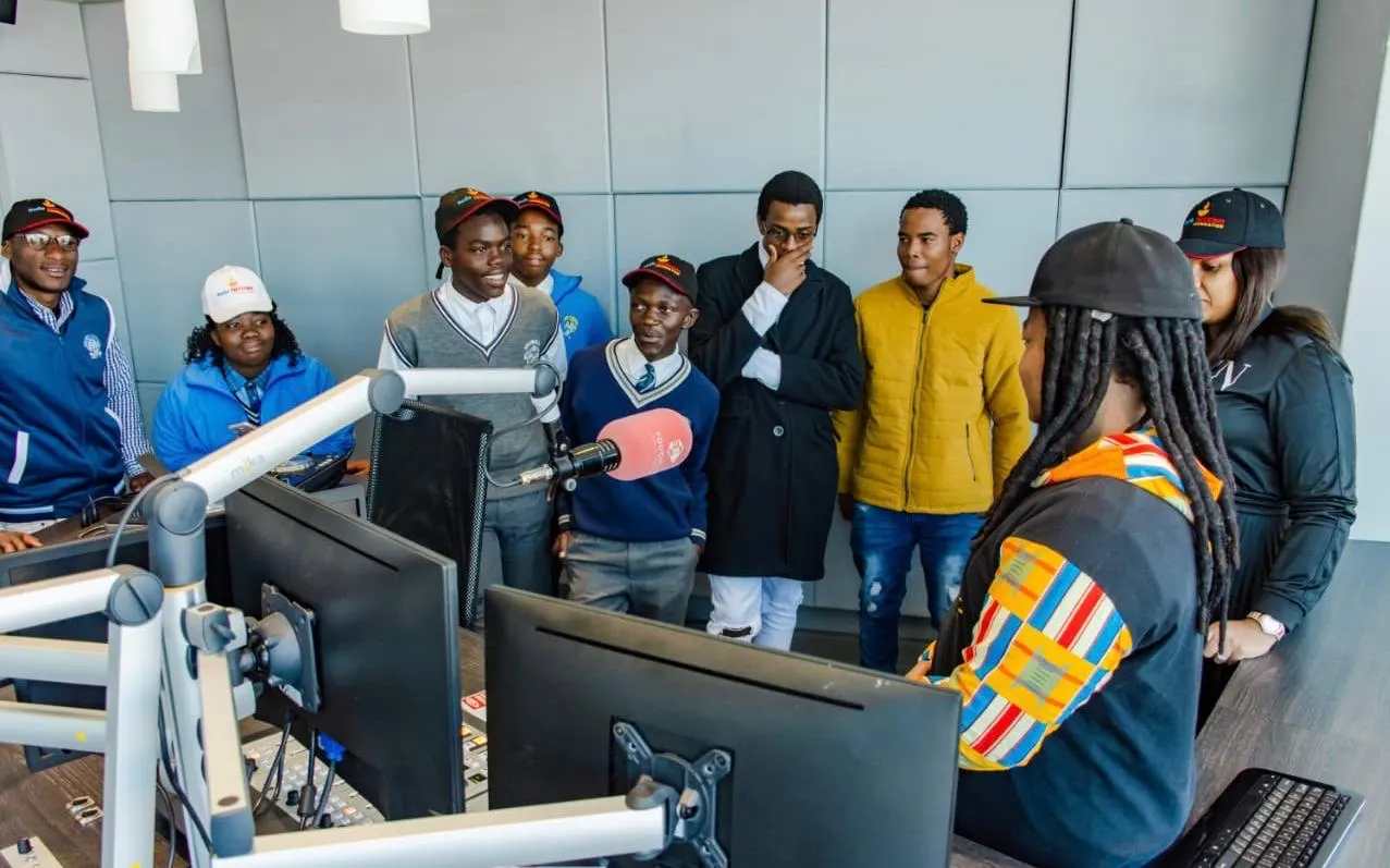 Learners in a radio studio with a presenter